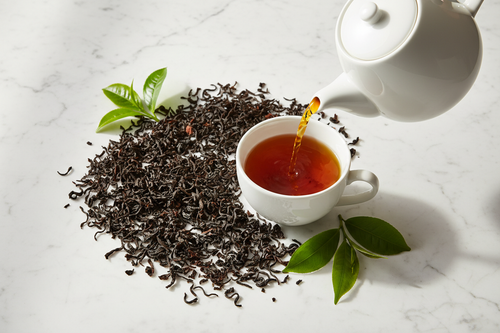 Fahari Ya Kenya loose leaf black tea lifestyle shot with teapot and cup